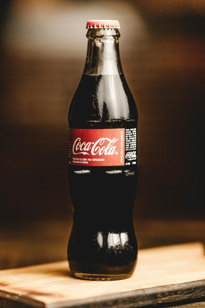 Close-up of a chilled Coca-Cola glass bottle, perfect for refreshing moments.